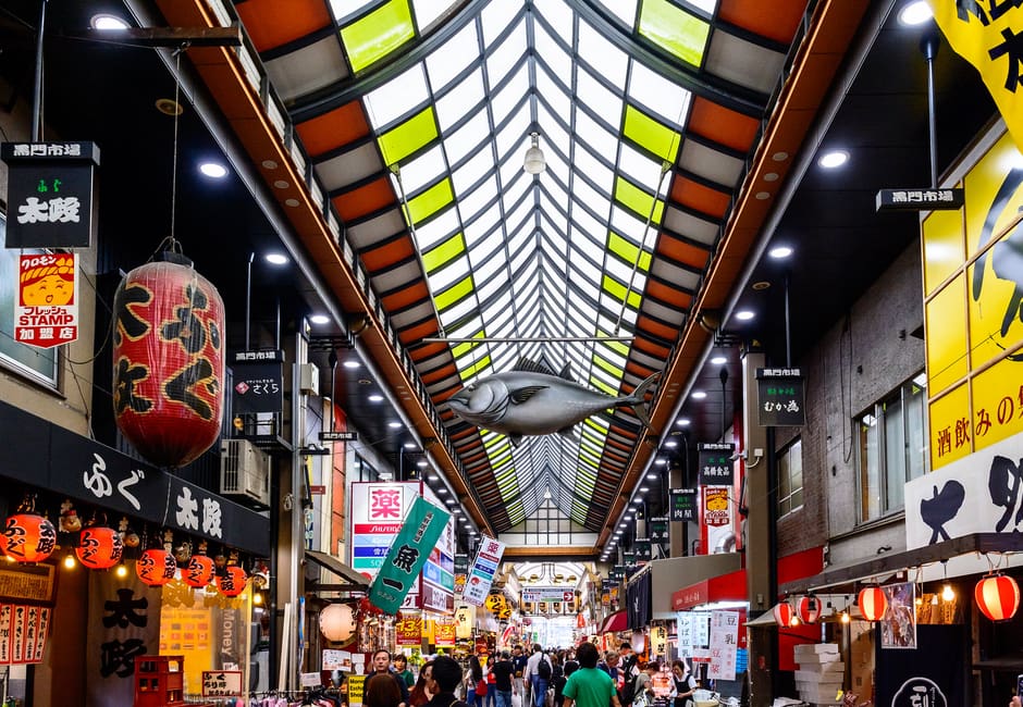 Kuromon Ichiba Market covered arcade with lanterns and food stalls in Osaka