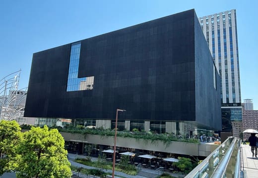 Black cube facade of the Nakanoshima Museum of Art beside the river in Osaka