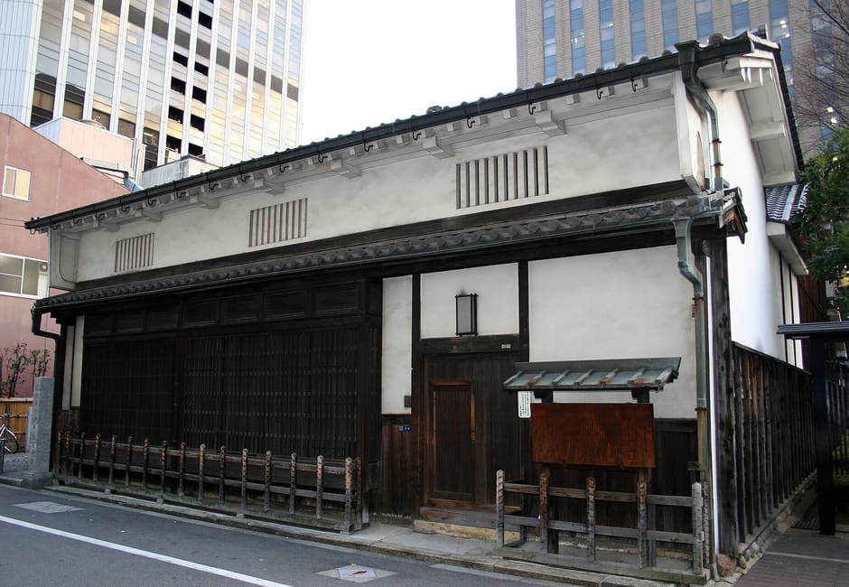 Street frontage of Tekijuku, the old Ogata Koan house, with white plaster walls and dark lattice