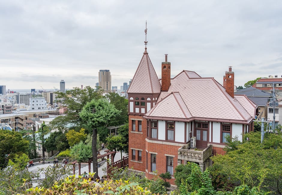 Weathercock House with its pointed tower among trees in Kitano, Kobe