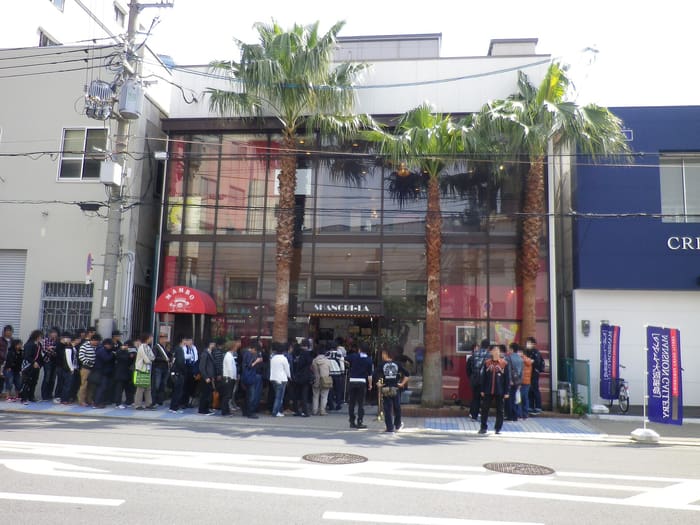 Shangri-La live house exterior in Umeda with palm trees and a queue at the entrance